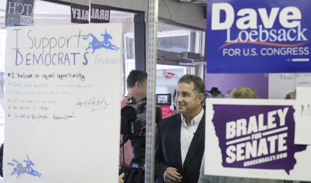 Democratic Senate candidate U.S. Rep. Bruce Braley, center, is seen reflected in a mirror as he speaks to supporters at a campaign stop, Monday, Nov. 3, 2014, in Ottumwa, Iowa. Braley is running against Republican State Sen. Joni Ernst for the U.S. Senate seat of Tom Harkin, who is not seeking reelection. (AP Photo/Charlie Neibergall)